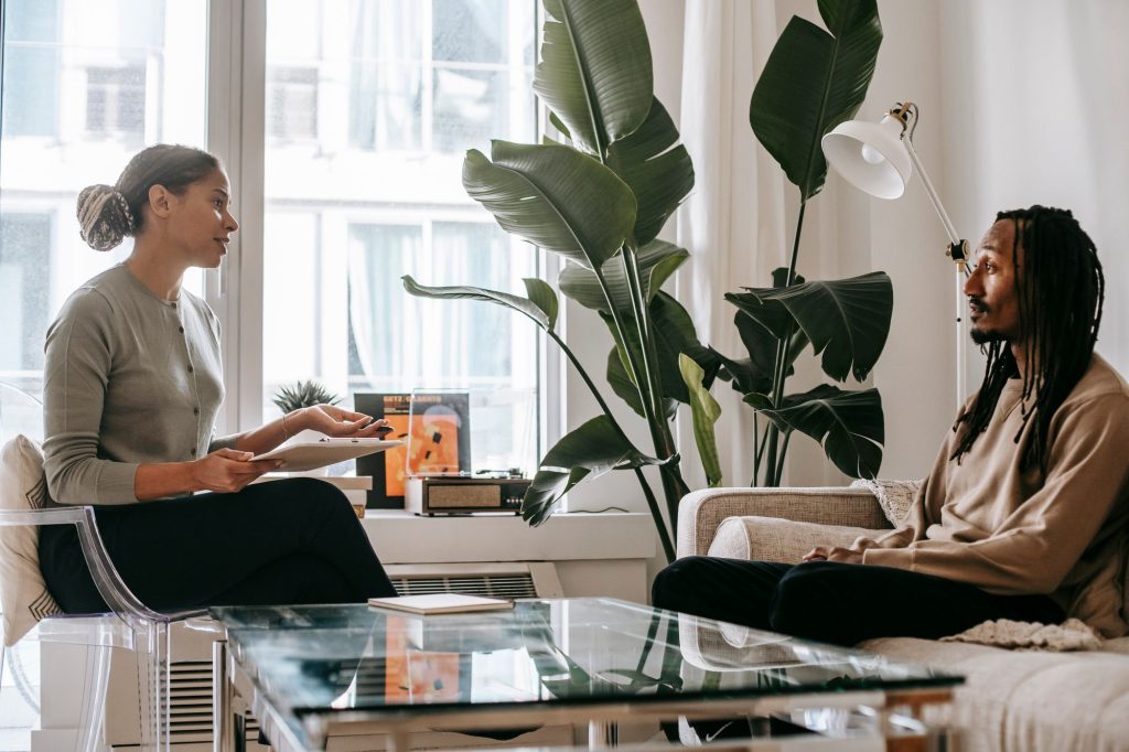 A counsellor listens to a client during a talking session