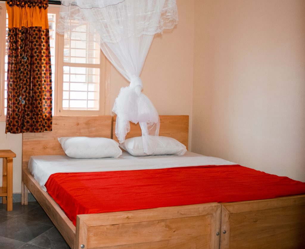 Bed fitted with an insecticide-treated mosquito net